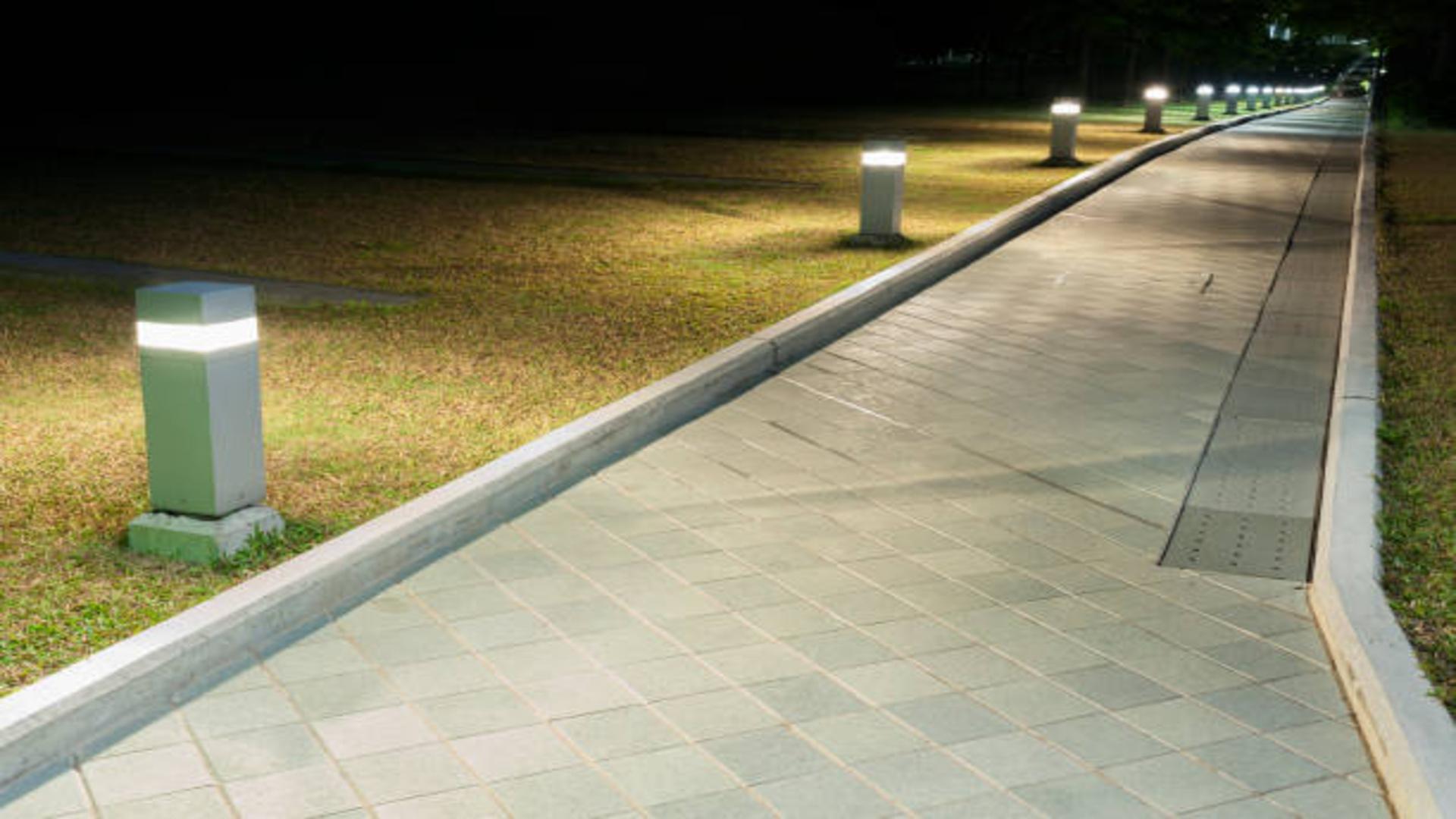 A modern garden pathway illuminated by stylish LED bollard lights.